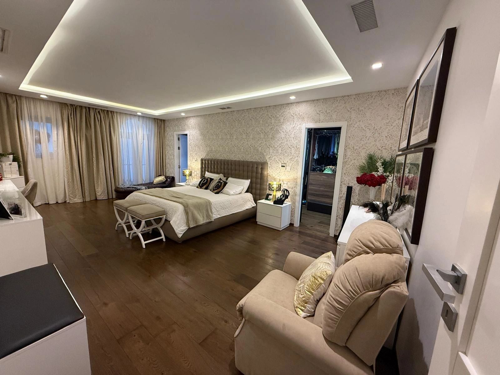 Main double bedroom with walk-in wardrobe and hardwood floors
